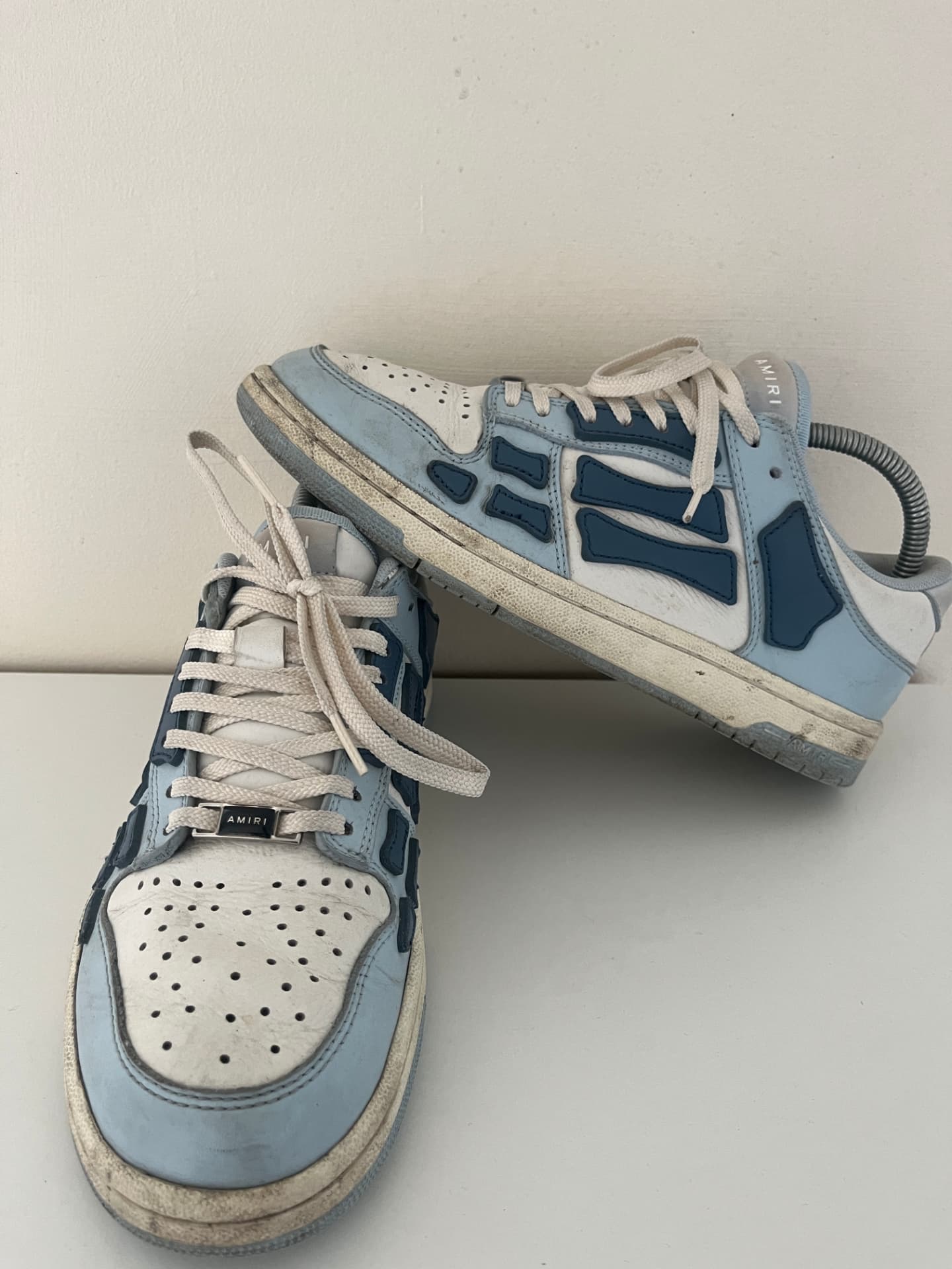 Scuffed blue and white Amiri Skel-Top Low sneakers with dirty midsoles